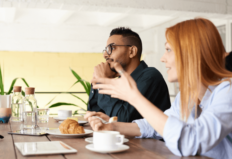 man and woman talking in a cafe
