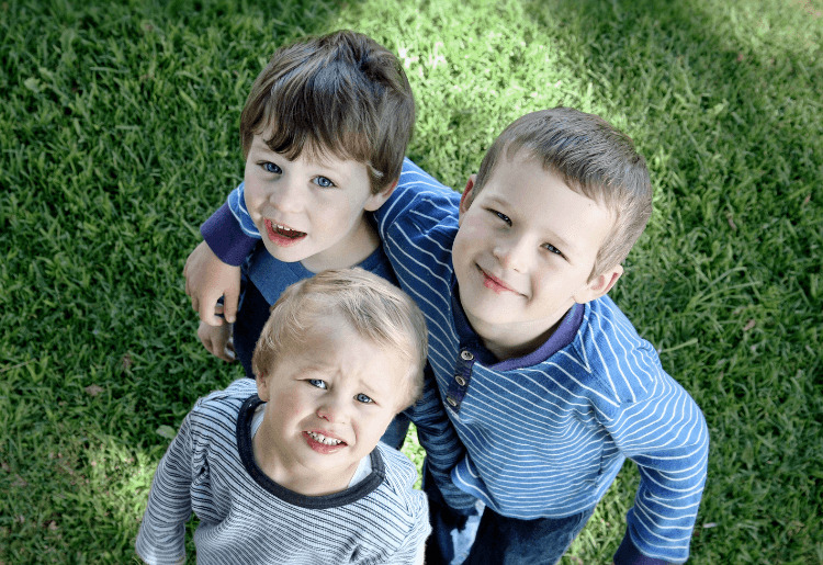 three boys looking up at camera