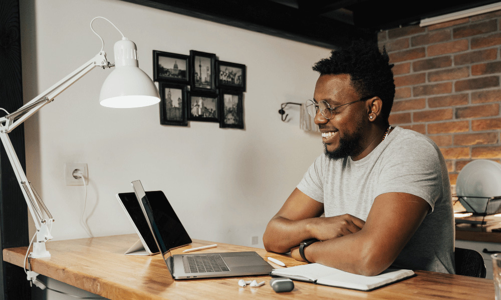 man smiling looking at laptop