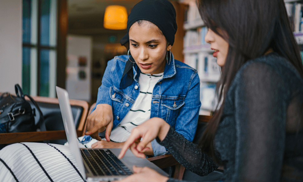 two women looking at laptop